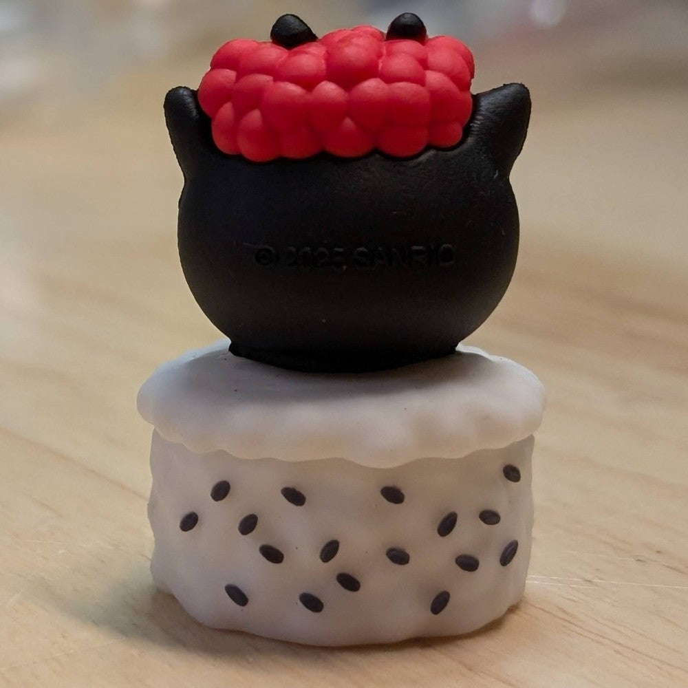 Go Figment figure showing black character with red topping sitting on white sushi base sprinkled with black seeds