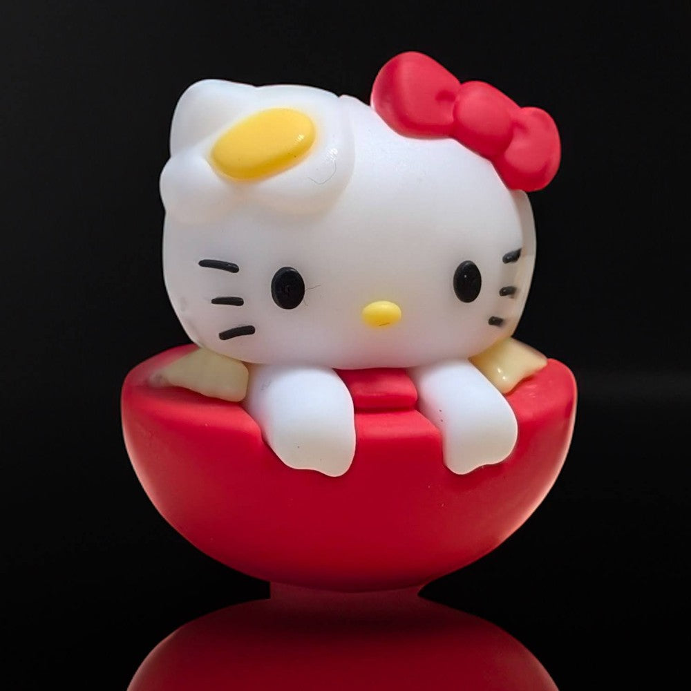 Go Figment Hello Kitty sushi collectible featuring character with red bow and egg detail sitting in red bowl base