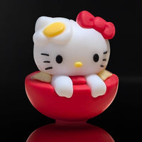 Go Figment Hello Kitty sushi collectible featuring character with red bow and egg detail sitting in red bowl base