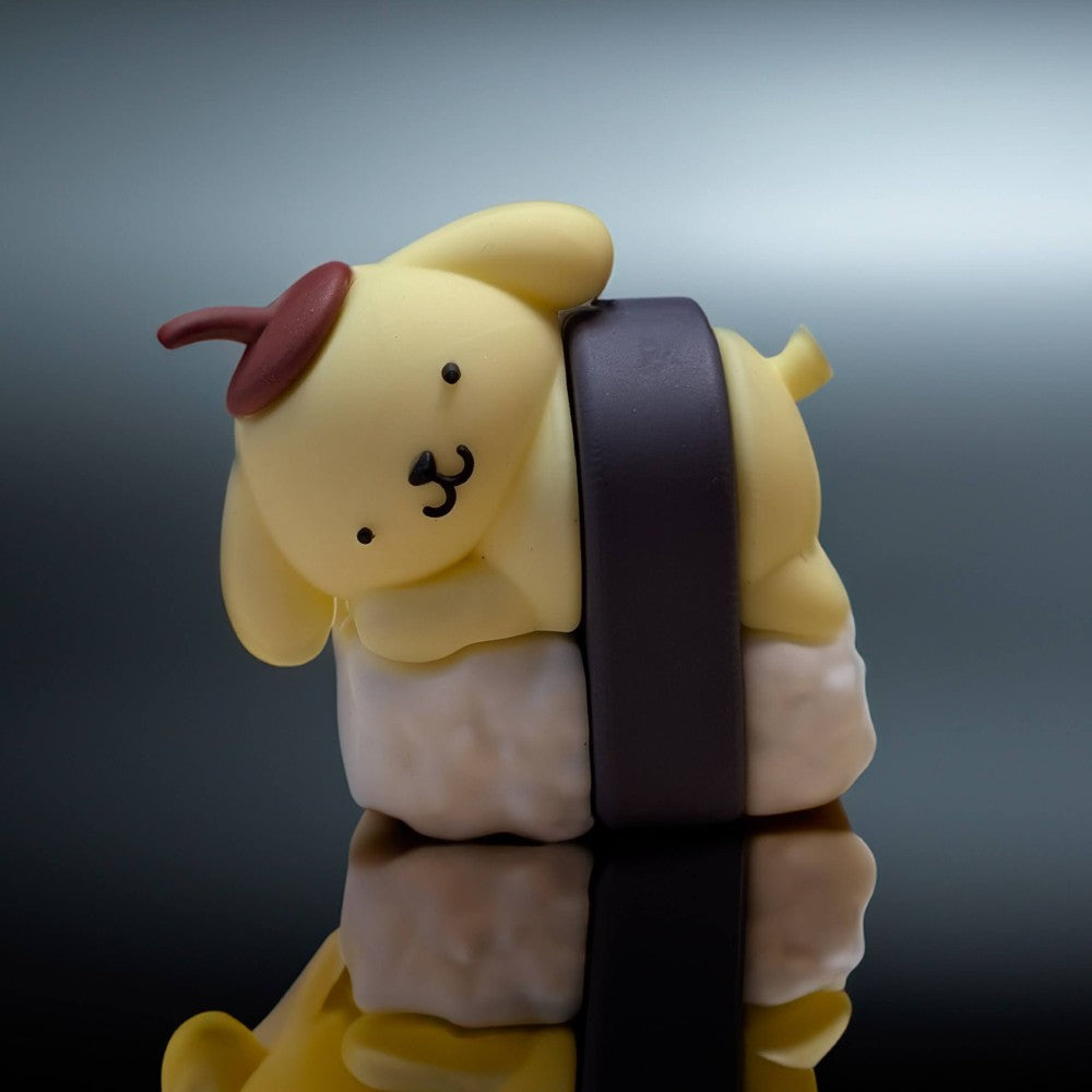 Go Figment collectible featuring yellow dog character with brown beret leaning on white sushi with dark seaweed wrap