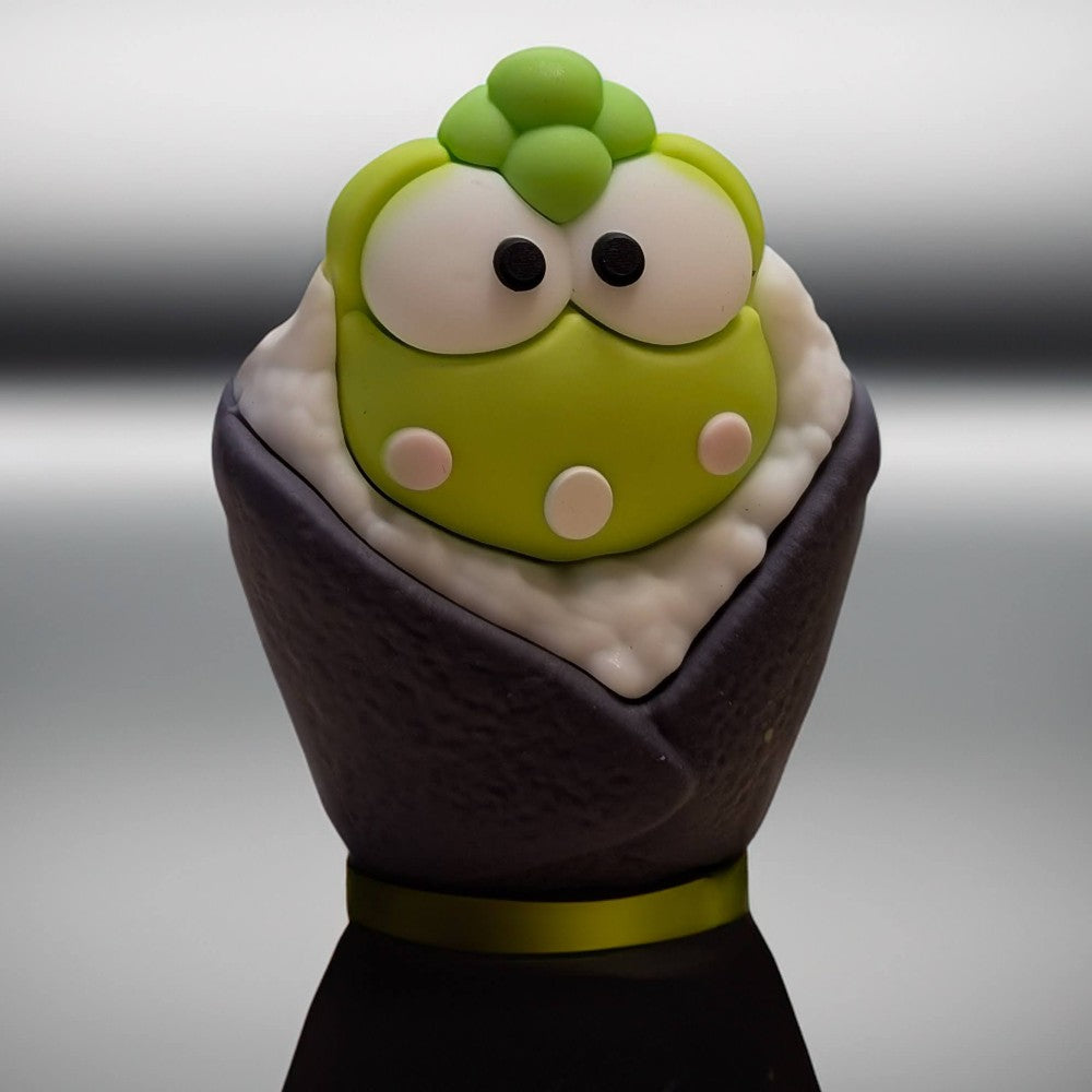 Go Figment collectible featuring green character with large eyes wrapped in dark seaweed sushi cone with rice detail