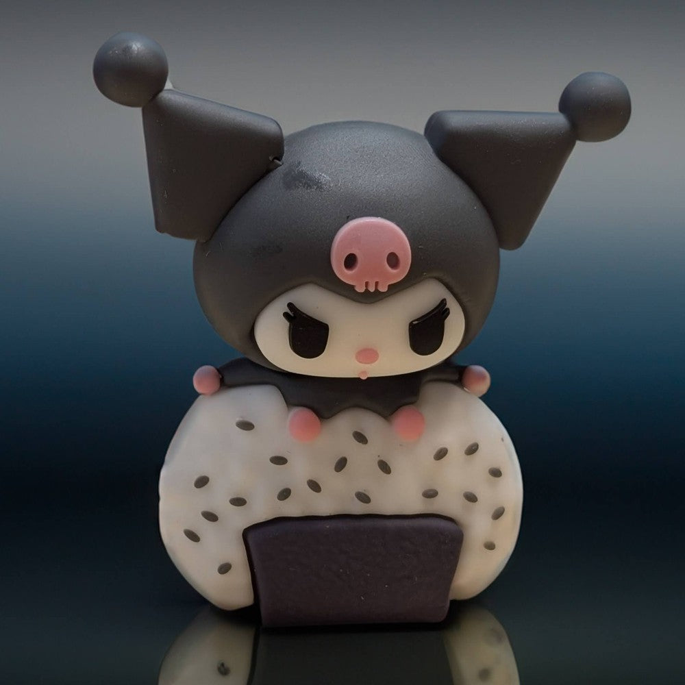 Go Figment Hello Kitty and Friends sushi capsule figure featuring Kuromi character holding a rice ball with sesame seeds