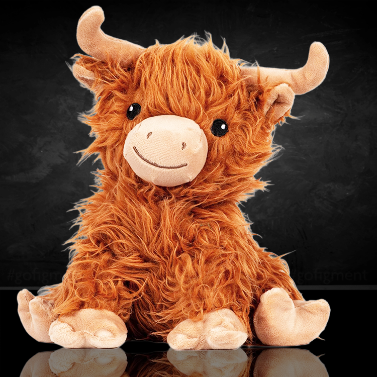 Soft plush Highland cow warm pal with curly fur and cute embroidered face sitting on reflective surface