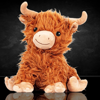Soft plush Highland cow warm pal with curly fur and cute embroidered face sitting on reflective surface