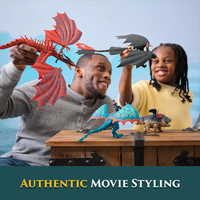 Father and daughter playing with How to Train Your Dragon final battle figure set including dragons and vikings