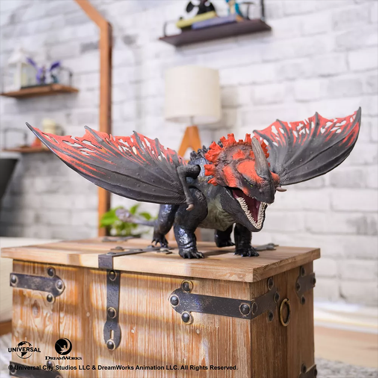Titan Red Death dragon action figure with spread wings and detailed scales on wooden chest display