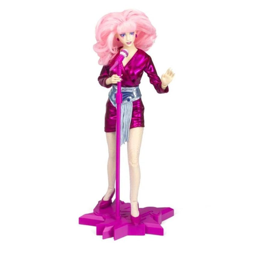 Jem and the Holograms 12 inch fashion doll by Loyal Subjects with pink hair and purple outfit on stage stand