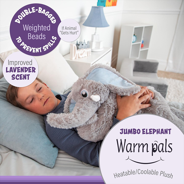Child lying on bed hugging a large lavender-scented jumbo elephant plush weighted with double-bagged beads