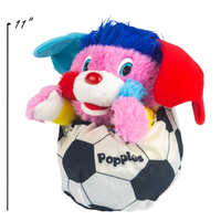 Colorful Popples plush toy tucked into a black and white soccer ball container