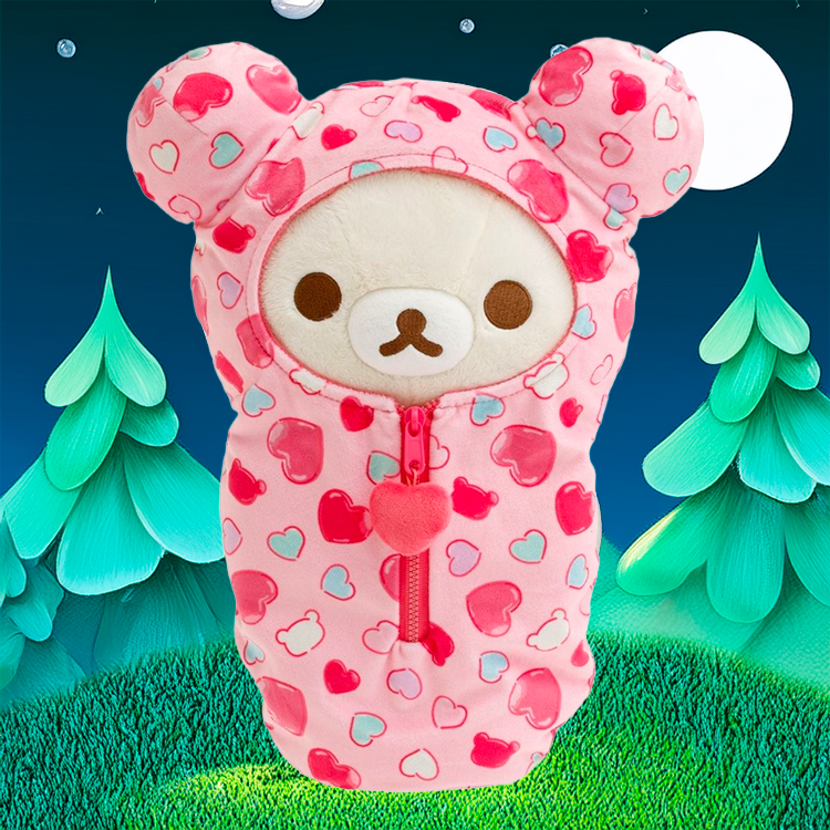 Korilakkuma plush sleeping bag with pink hearts and zipper by San-X against nighttime forest backdrop