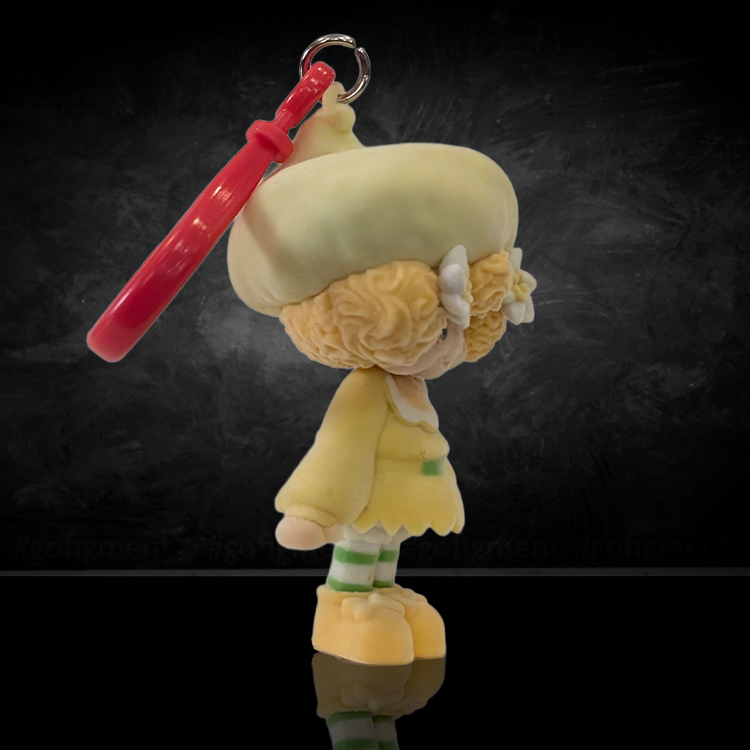 UCC World of Strawberry Shortcake soft flocked mini figure clip with pale yellow outfit and red plastic hook attachment
