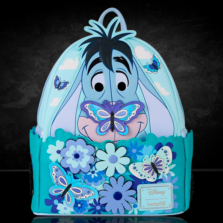 Loungefly mini-backpack featuring Eeyore with butterflies and interactive spinning flowers in pastel blue tones.