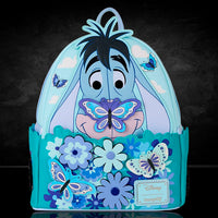 Loungefly mini-backpack featuring Eeyore with butterflies and interactive spinning flowers in pastel blue tones.