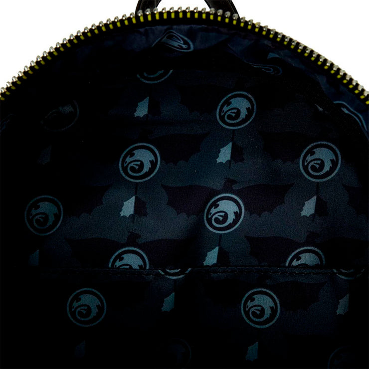 Close-up of the interior lining of the Loungefly How to Train Your Dragon Toothless mini-backpack showing dragon and wing patterns.