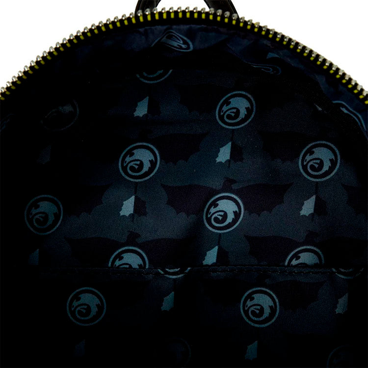 Close-up of the interior lining of the Loungefly How to Train Your Dragon Toothless mini-backpack showing dragon and wing patterns.