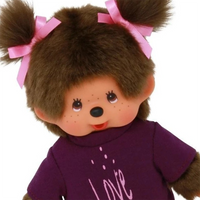 Brown furry doll with pink hair bows and purple shirt featuring a "Love" design on the front