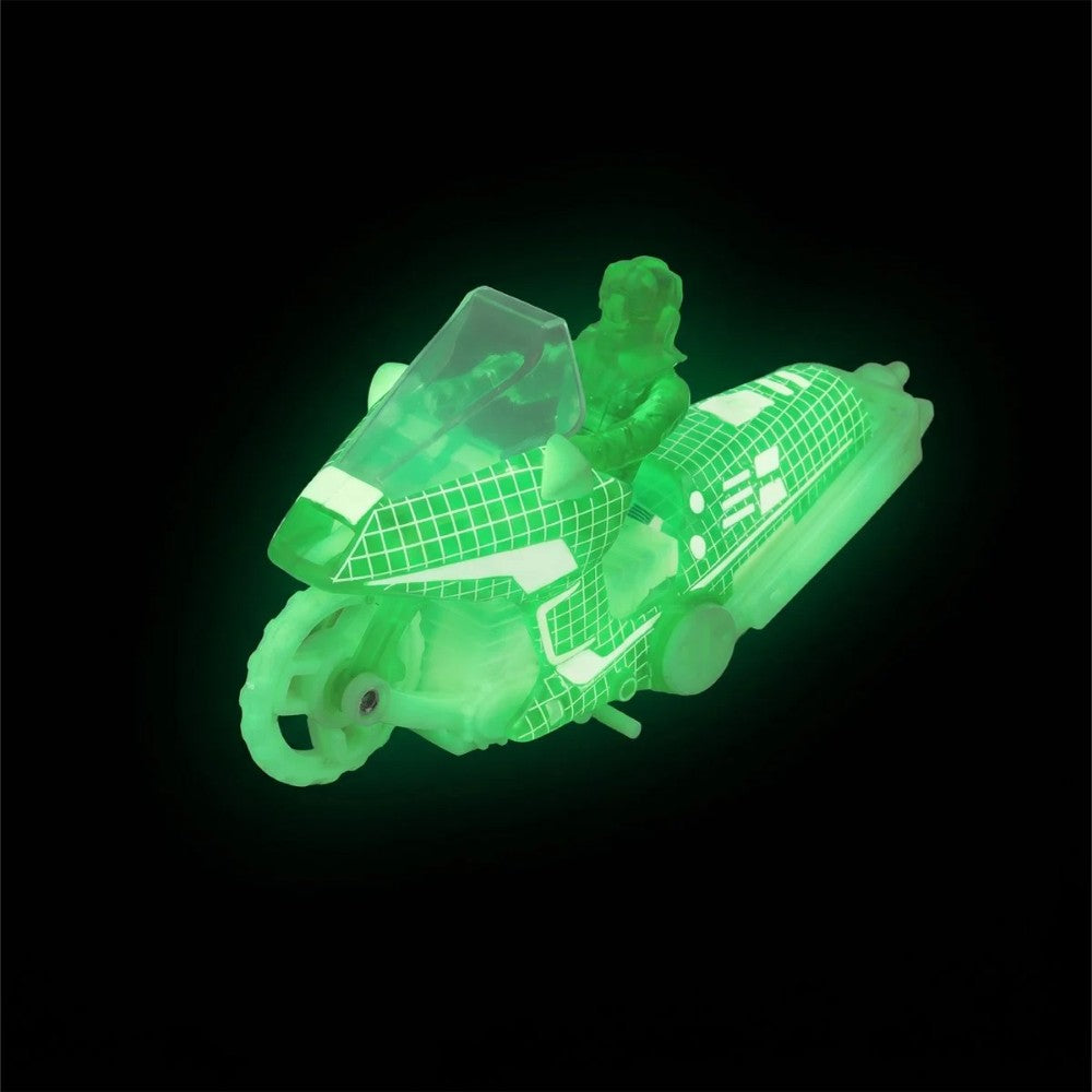 Translucent green toy vehicle with a seated figure against a black background