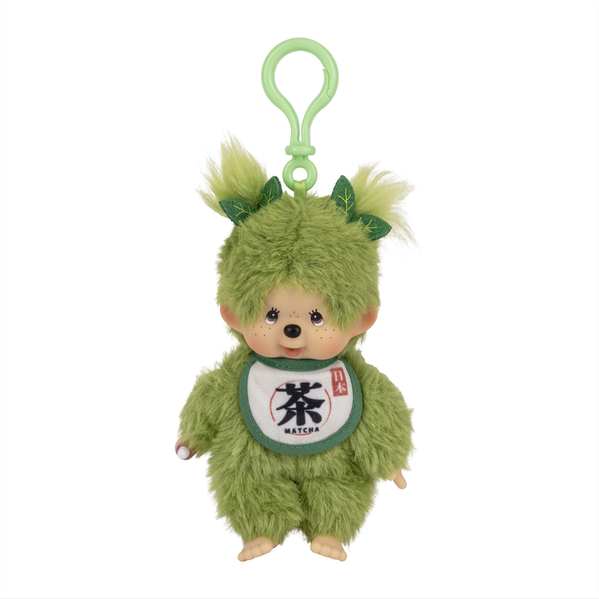 Green furry plush character with a loop, leaf-like ears, and a matcha bib