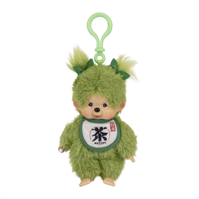 Green furry plush character with a loop, leaf-like ears, and a matcha bib
