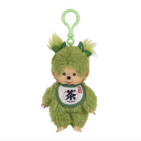 Green furry plush character with a loop, leaf-like ears, and a matcha bib