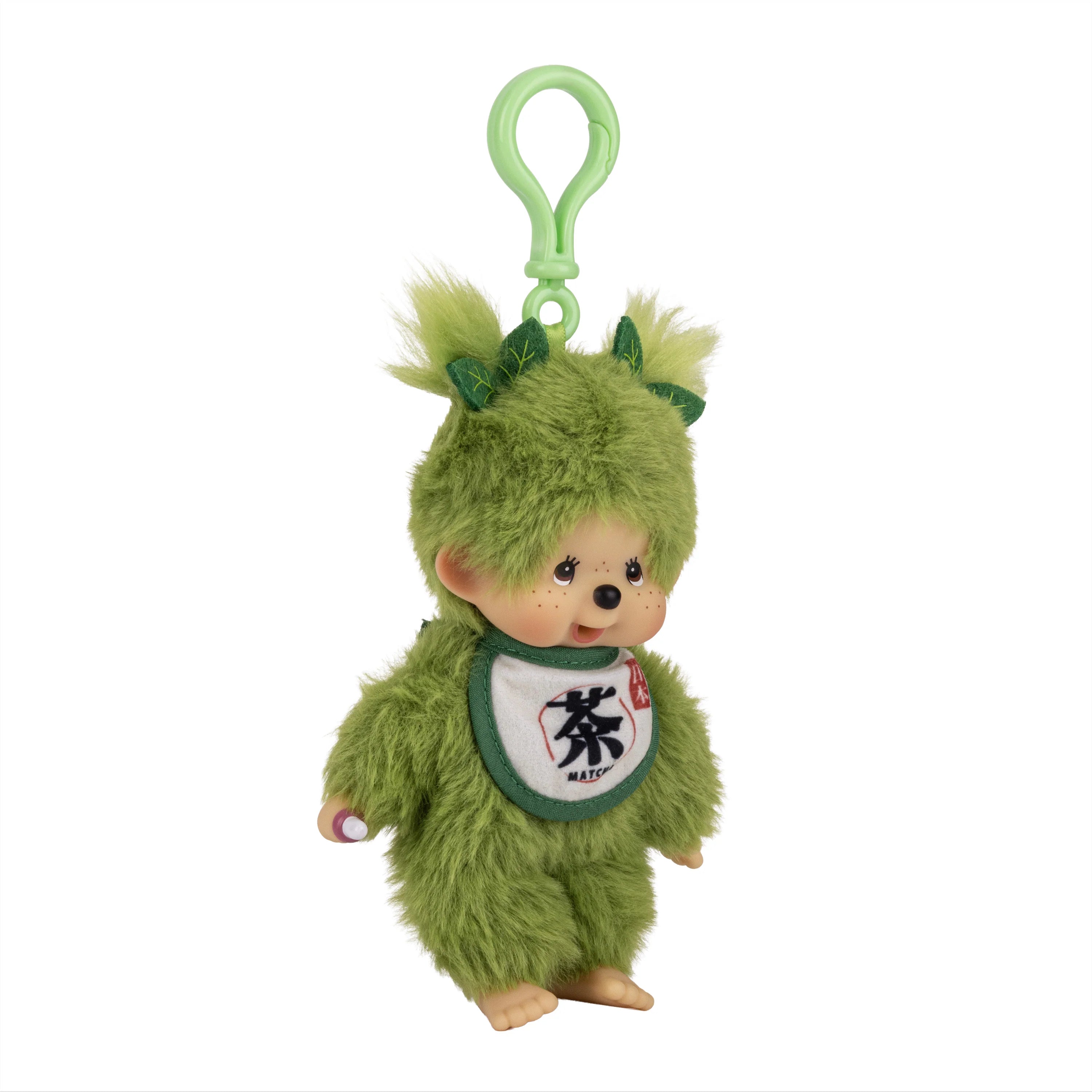 Green furry character plush keychain with leafy ears, a white bib, and a smiling face