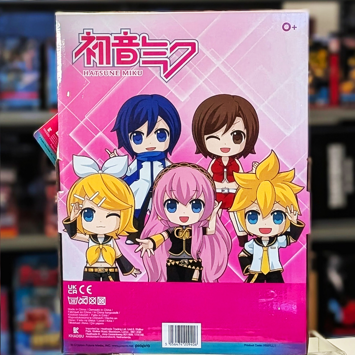 Back of UCC branded pink box featuring colorful chibi Vocaloid characters on a geometric pink background
