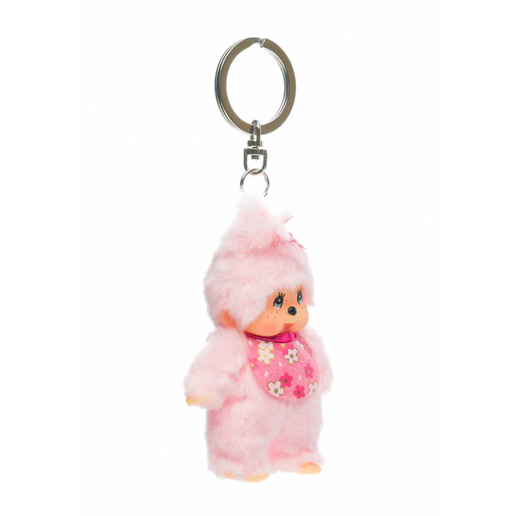 Sekiguchi Monchhichi 4-inch plush keychain in soft pink with cherry blossom bib and thumb-sucking pose.