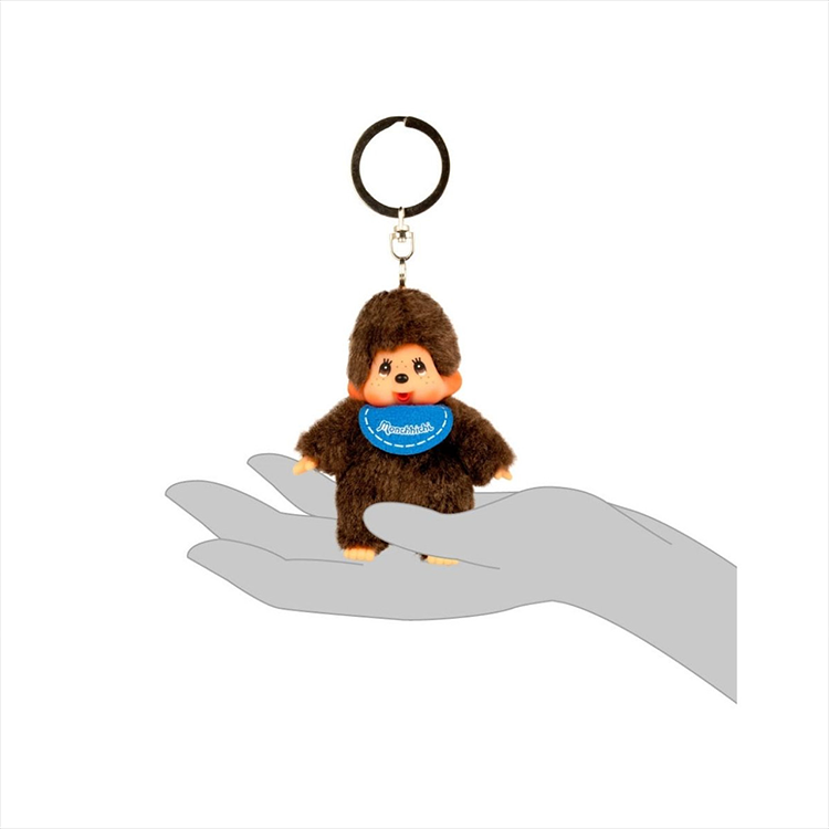 Sekiguchi Monchhichi 4-inch plush keychain with blue bib held in a hand, soft and collectible design.