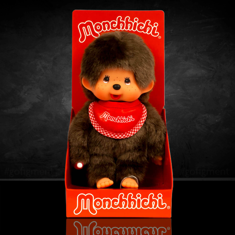 Sekiguchi Monchhichi Classic 8-inch plush with red bib in original packaging on black background