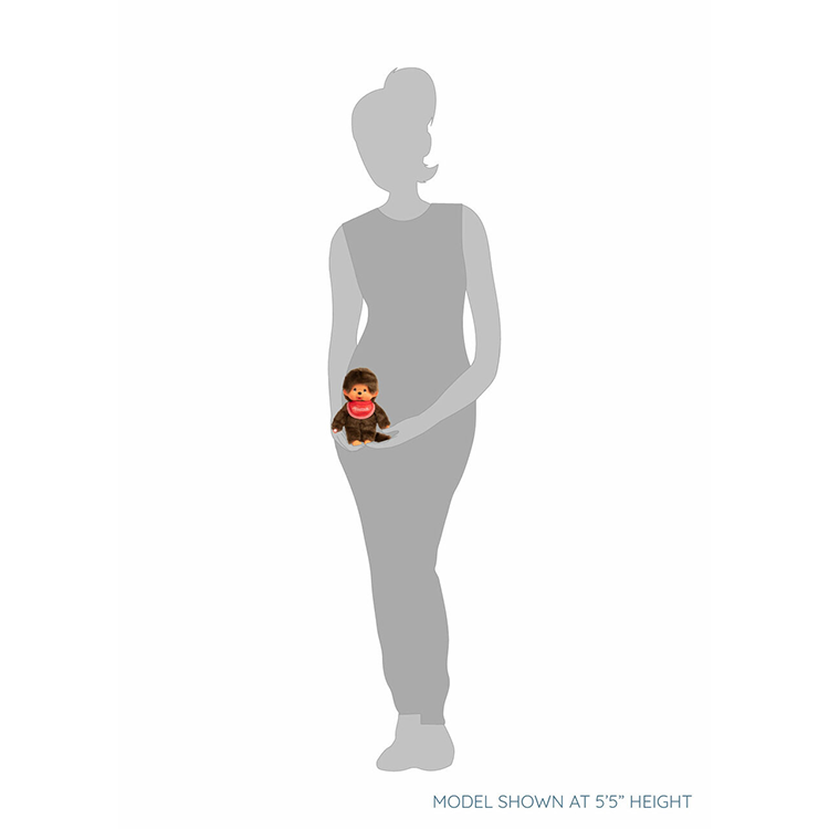 Sekiguchi Monchhichi Classic 8-inch plush monkey with red bib shown held by a standing figure for size reference