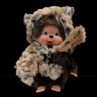 Sekiguchi Monchhichi 8-inch plush monkey wearing leopard hood and cape with thumb-sucking pose on black background