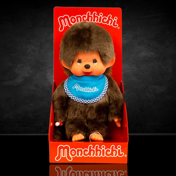 Sekiguchi Monchhichi Classic 8-inch plush monkey with blue bib in original red packaging display.