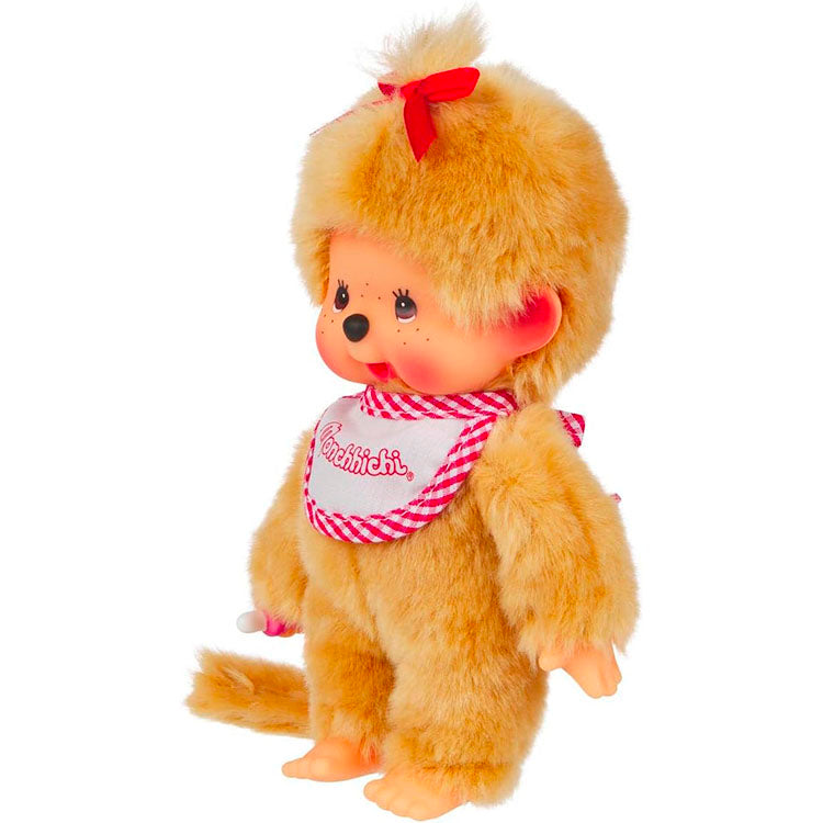 Sekiguchi Monchhichi Girl plush with beige fur, red bow, and signature thumb-sucking pose standing on white background