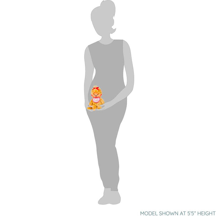 Sekiguchi Monchhichi Girl 8 inch beige plush monkey doll with thumb in mouth and red bow sitting on a hand.