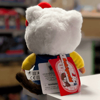 Back view of 8-inch Sekiguchi Monchhichi Hello Kitty plush doll with tags on white surface and blurred background