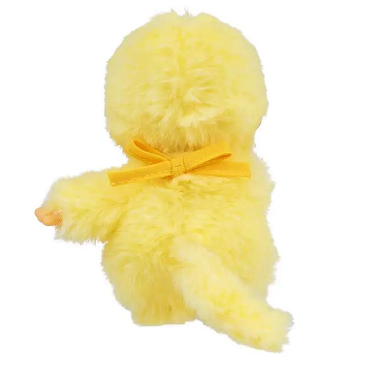 Sekiguchi Monchhichi plush in sunny yellow wearing a bow, showing its back and tail in soft fluffy material.