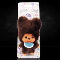 Sekiguchi 4-inch Monchhichi plush keychain dressed as a brown bear with blue checkered bib and thumb in mouth