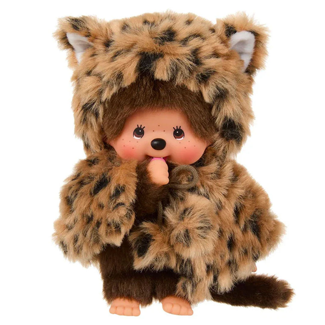Sekiguchi Monchhichi plush monkey wearing a soft leopard hood and cape with thumb in mouth