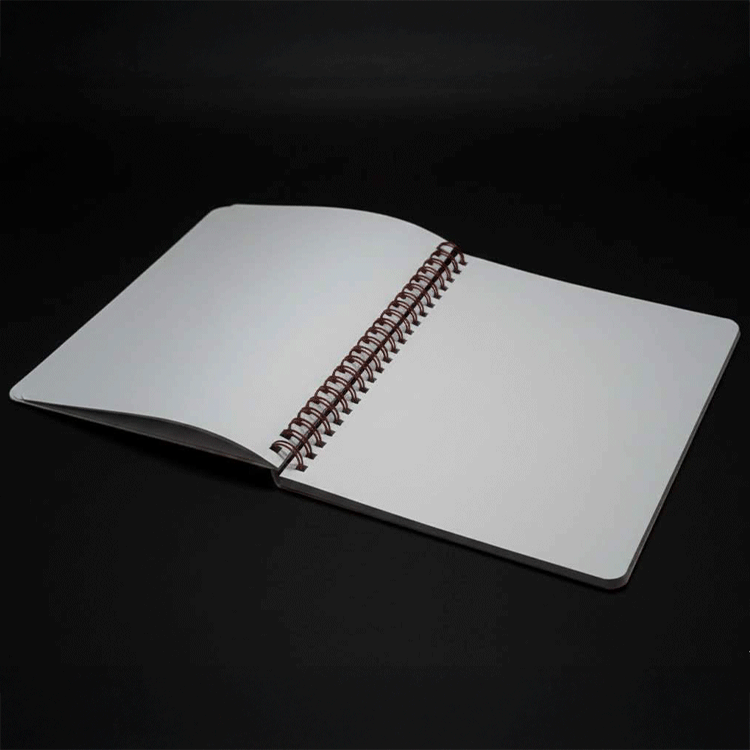 Go Figment spiral-bound reusable sticker book open to blank white pages on dark background