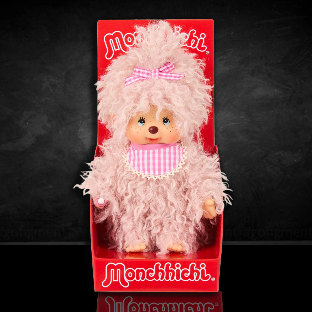 Sekiguchi Monchhichi plush doll with fluffy pink beige fur, gingham bib and bow, in classic thumb-sucking pose