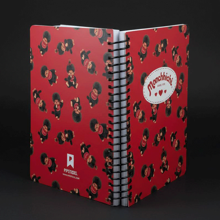 Go Figment Monchhichi red spiral notebook with playful character pattern and Monchhichi logo badge on front cover