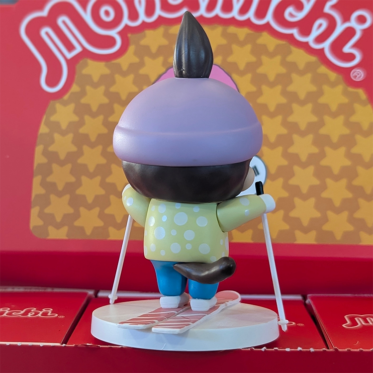 Sekiguchi Boy Monchhichi vinyl figure skiing with purple helmet yellow shirt on white snow base
