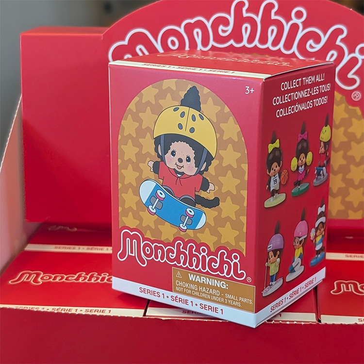 Sekiguchi Monchhichi Series 1 blind box featuring a skateboarder vinyl figure with yellow helmet and red shirt.