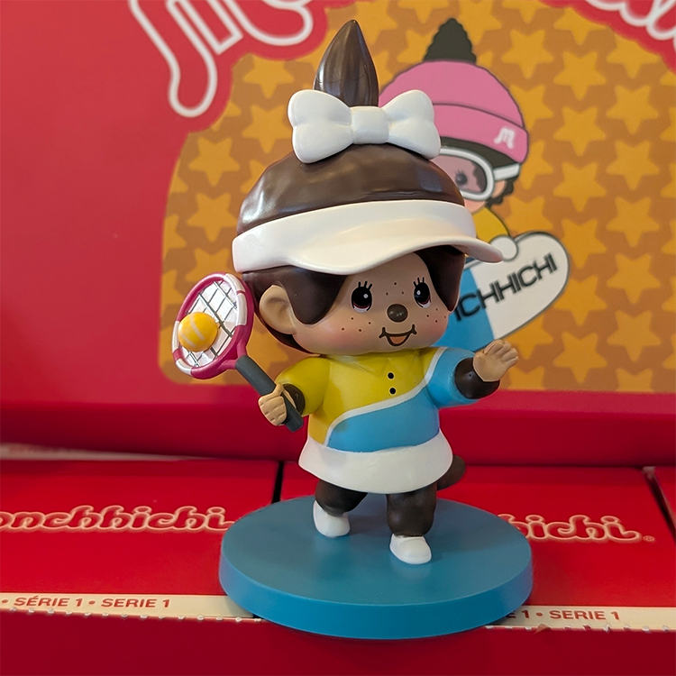 Sekiguchi Monchhichi Girl Tennis Player vinyl figure in yellow and blue outfit on a blue court-themed stand