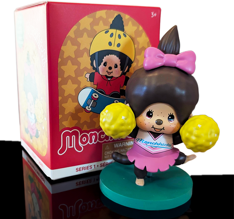 Sekiguchi Girl Monchhichi cheerleader figure in pink outfit with yellow pom-poms on green stand from Sports Series 4.