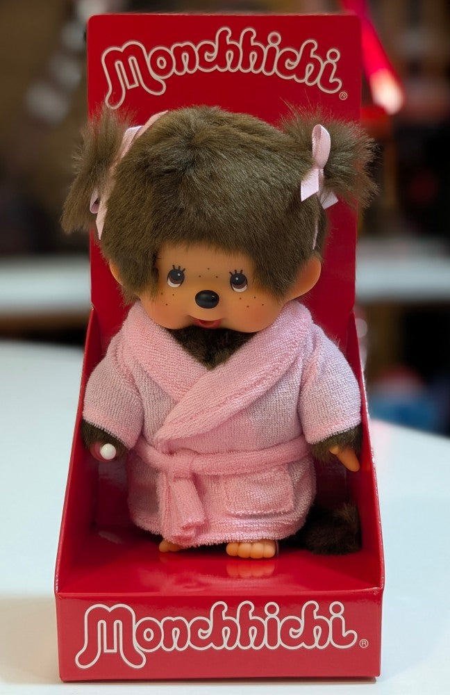Sekiguchi Monchhichi girl plush in pink bathrobe with pigtails and thumb in mouth displayed in branded red box