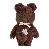 Back view of a brown plush bear with a cream bow and attached tag