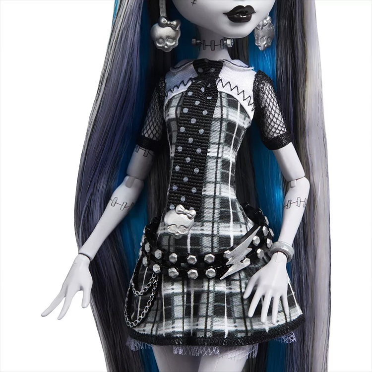 Monster High Frankie Stein doll by Mattel wearing black and white plaid dress with skull accessories and blue hair streaks.