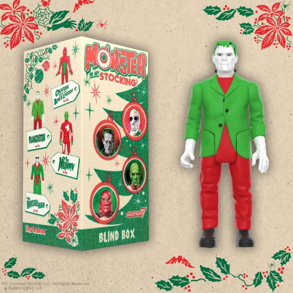 Hasbro Universal Monsters ReAction Frankenstein action figure in holiday outfit next to festive blind box packaging