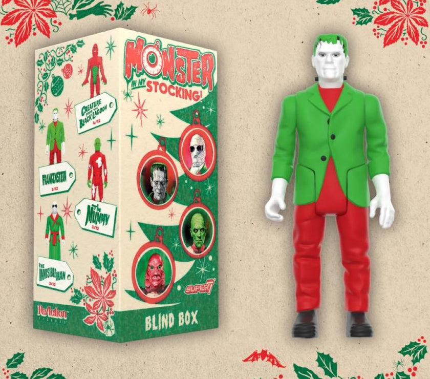 Hasbro Universal Monsters ReAction Frankenstein action figure in holiday outfit next to festive blind box packaging